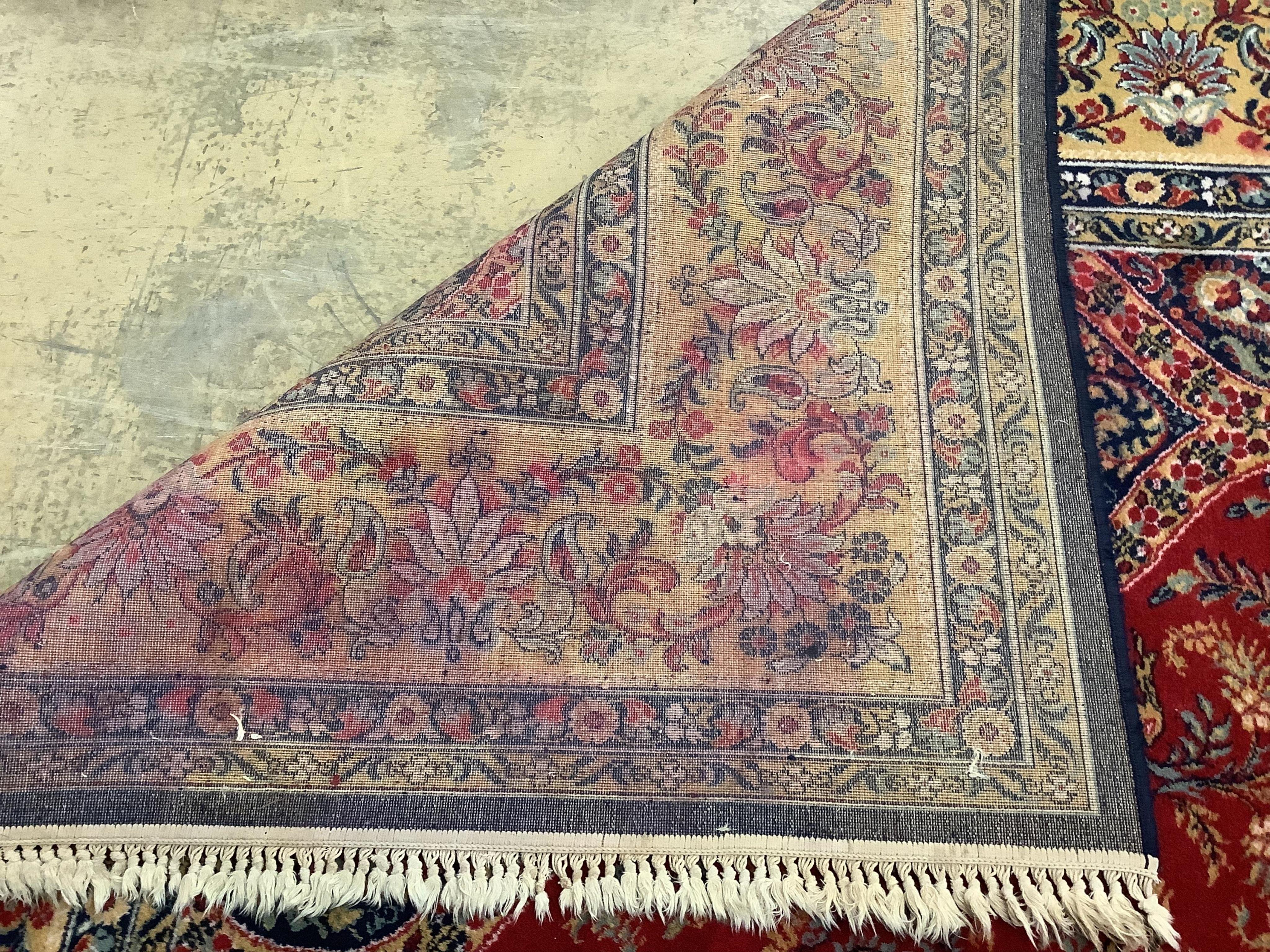 A Kashmiri style red ground carpet, 360 x 270cm. Condition - good